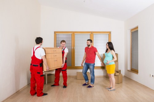 Professional movers handling belongings in Holland Park