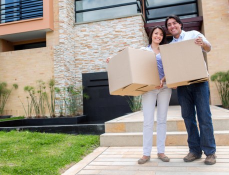 Professional movers handling packed boxes